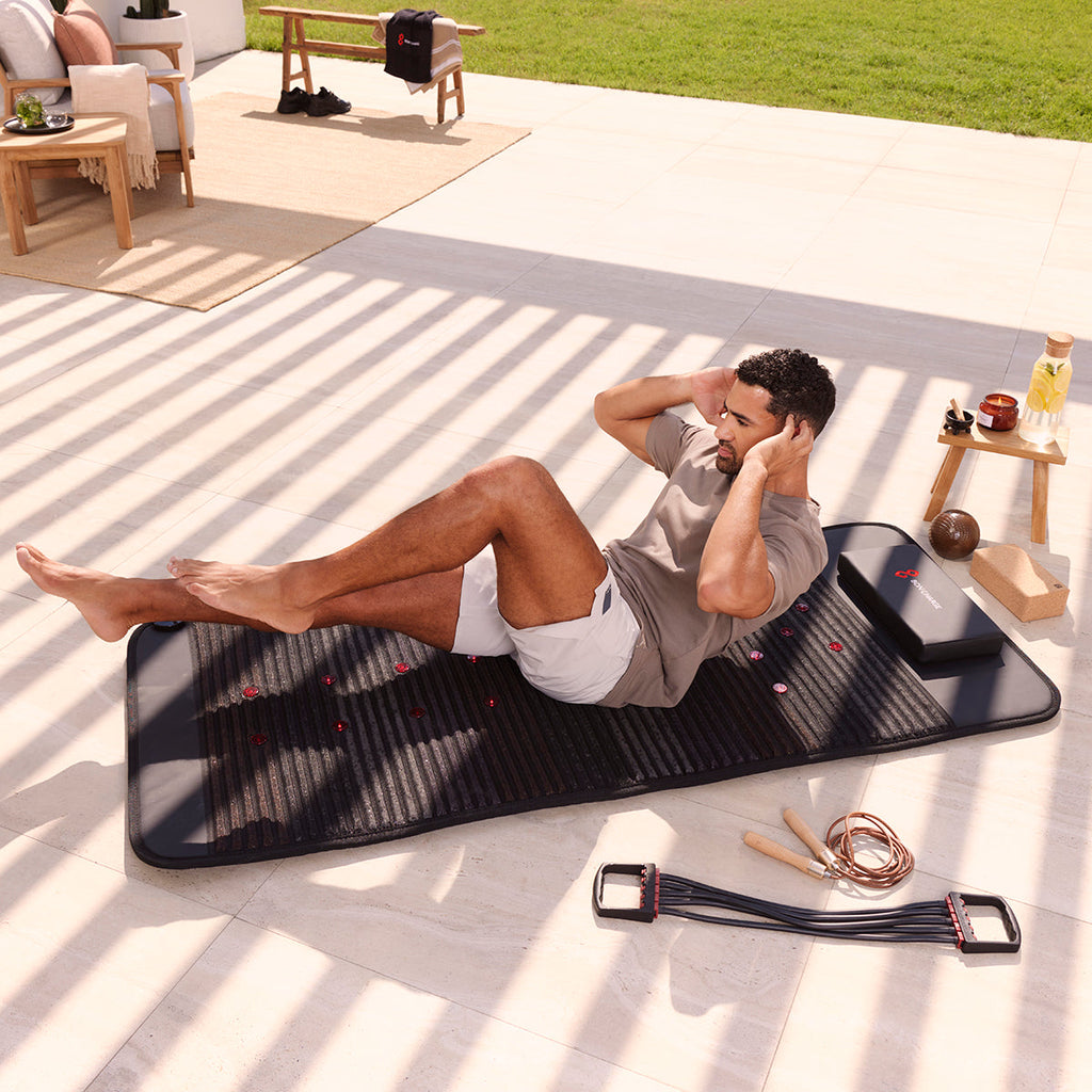 Sourcing reference: infrared PEMF mat in use, person lying full length