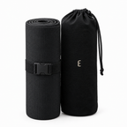 Deep Delta Field Mat rolled with its strap beside the carry bag, on white