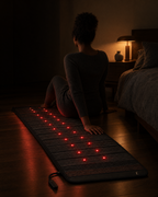 Deep Delta Field Mat on a bedroom floor with a person sitting on its edge at night