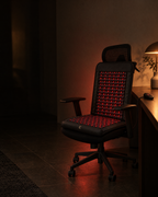 Neural Chair Mat fitted to an office chair in a dark home office at night